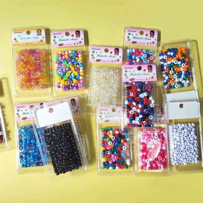 Colorful Plastic Braid Beads for Women & Kids Multi-Colored for Hair arranged in packs on a yellow surface.