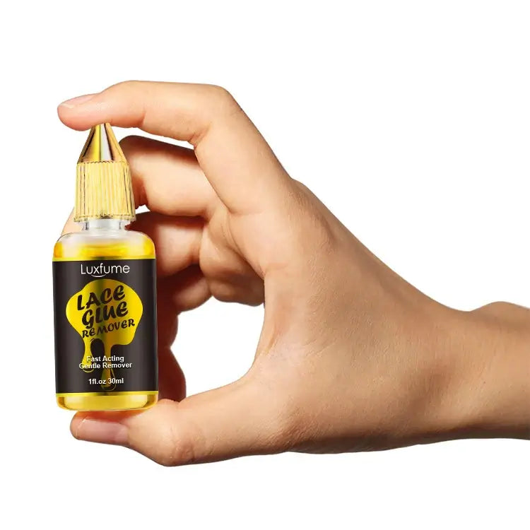 Luxfume Non-Irritating Lace Glue/Adhesive Remover - 1oz, held in a hand for easy application and use.