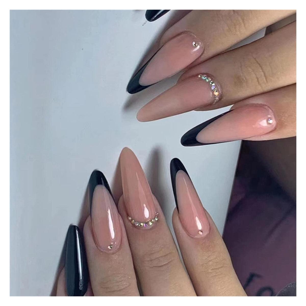 Hand wearing Black French Tip Almond press-on nails