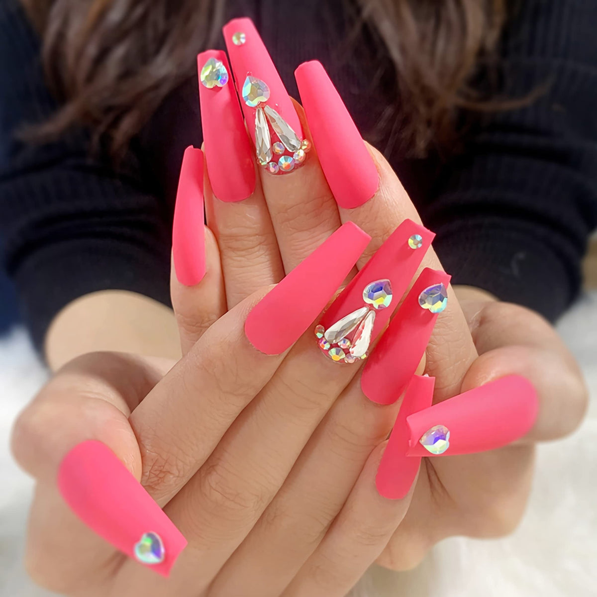 Hand wearing Coral Pink Matte Coffin with Rhinestones press-on nails