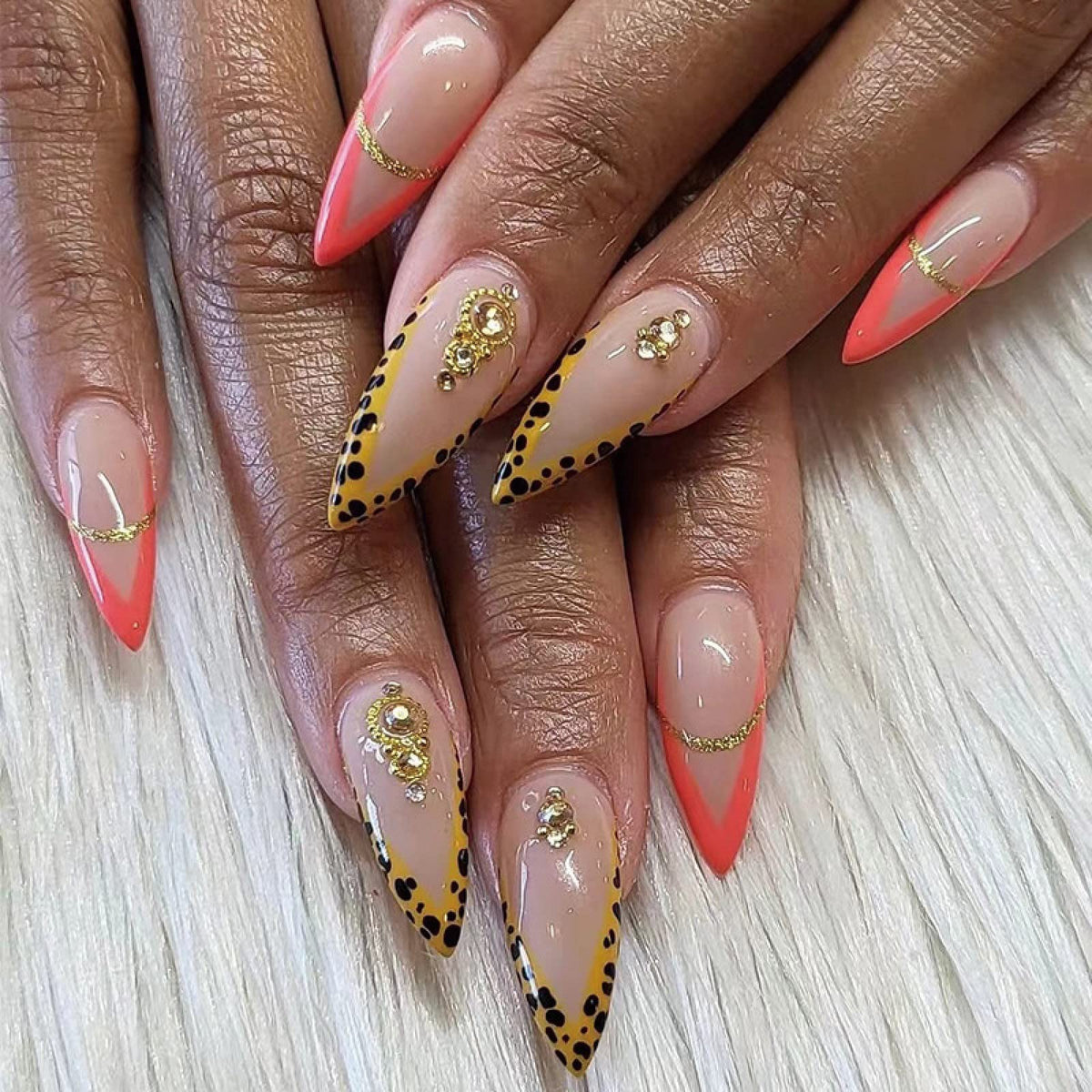 Hand wearing Leopard & Coral French Stiletto press-on nails