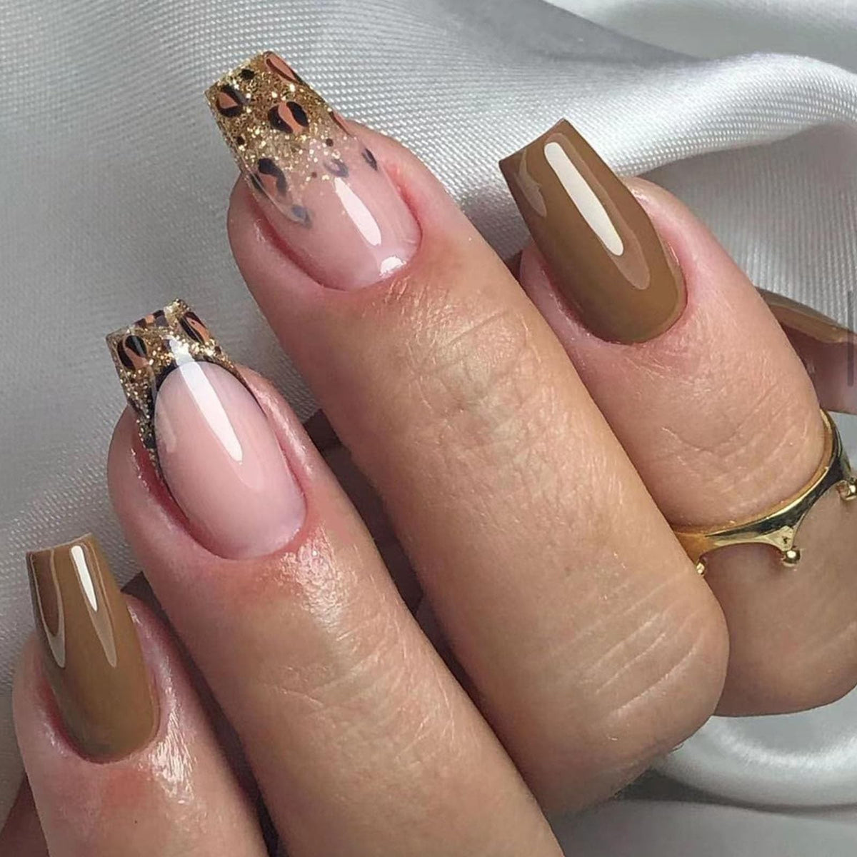 Hand wearing Mocha Brown & Leopard Coffin press-on nails