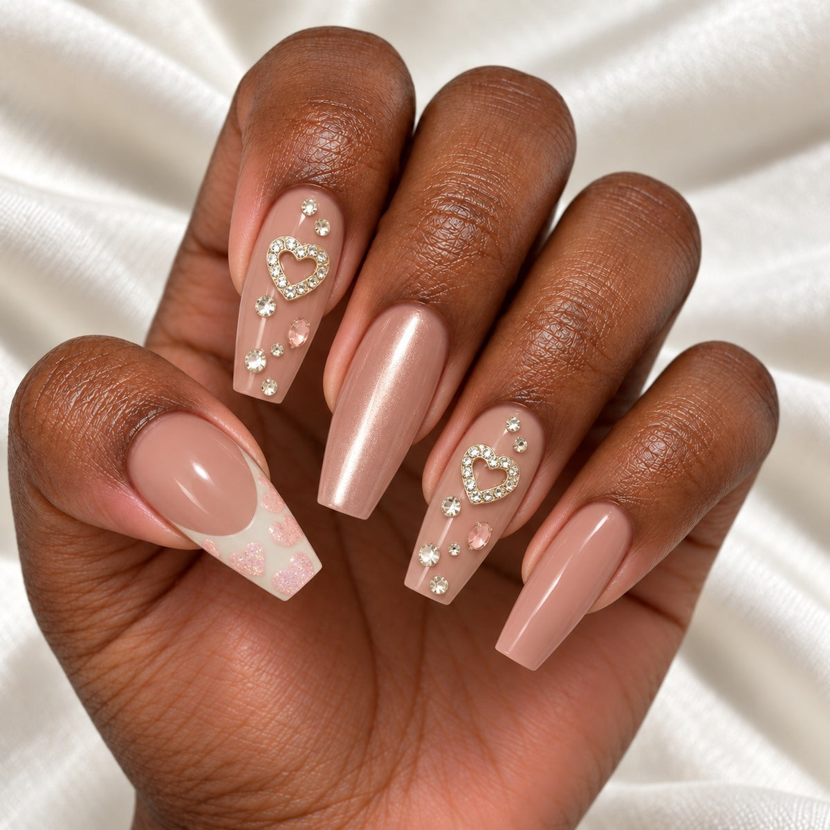 Hand wearing Nude Pink Coffin with Rhinestone Heart press-on nails