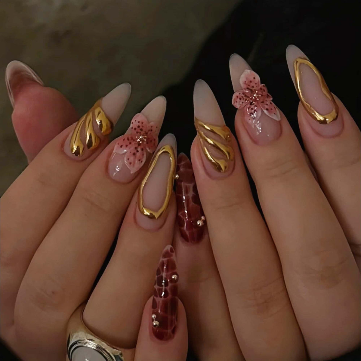 Hand wearing Pink Flower & Gold Swirl Almond press-on nails