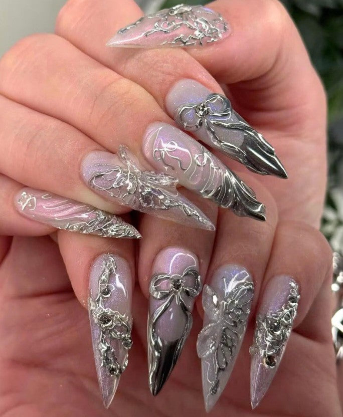 Hand wearing Silver Chrome 3D Bow Stiletto press-on nails