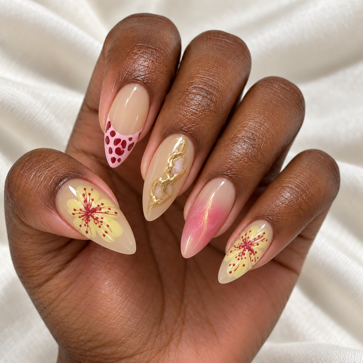 Hand wearing Sunset Floral & Gold Swirl Almond press-on nails